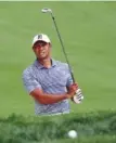  ?? AP PHOTO/NAM Y. HUH ?? Tiger Woods watches his ball after hitting from a sand trap on the 14th hole during the pro-am round of the BMW Championsh­ip golf tournament at Medinah Country Club on Wednesday.