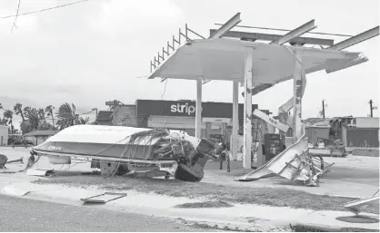  ?? NICK OZA, USA TODAY NETWORK ?? Port Aransas, Texas, a Gulf Coast tourist town, is left to pick up the pieces after Hurricane Harvey blew apart seaside businesses and houses and dumped torrents of rain. City officials worked to bring back basic services, so residents could return to...