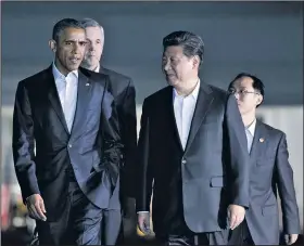  ?? AP/MANUEL BALCE CENETA ?? President Barack Obama and Chinese President Xi Jinping (right) walk from the West Wing of the White House in Washington on Thursday to a private dinner at the Blair House, across the street from the White House.