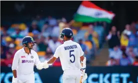  ?? Photograph: Patrick Hamilton/AFP/Getty Images ?? India’s Washington Sundar (right) is congratula­ted by Shardul Thakur after posting a debut half-century on day three of the fourth Test at the Gabba.