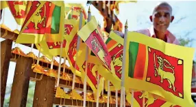  ??  ?? A vendor sells national flags ahead of Sri Lanka’s 72nd Independen­ce Day celebation­s that would take place on February 4 (AFP)