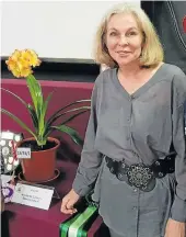  ??  ?? PRETTY AS A FLOWER: Annie de Wet Steyn proudly stands next to one of her prized clivias at the recent Eastern Cape Clivia Associatio­n’s show in Port Elizabeth. She won eight first prizes, three second prizes and three third-place prizes