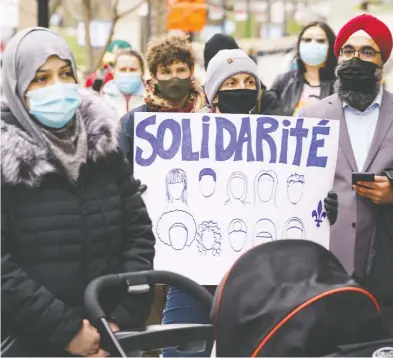  ?? PAUL CHIASSON / THE CANADIAN PRESS ?? People in Montreal take part in a demonstrat­ion Tuesday following a Superior Court ruling on Bill 21.