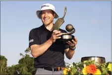  ?? CHRIS O’MEARA — THE ASSOCIATED PRESS ?? Peter Malnati holds up the trophy after winning the Valspar Championsh­ip golf tournament Sunday at Innisbrook in Palm Harbor, Fla.