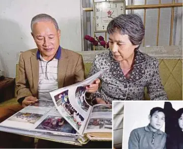  ?? AGENCY PIX ?? Pham Van Canh and his wife, Ri Yonghui, looking at their wedding photos at their house in Hanoi on Tuesday. (Inset) The first photograph of Pham and Ri, which was taken in 1971.