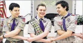  ?? LUIS M. ALVAREZ / ASSOCIATED PRESS 2014 ?? Pascal Tessier (center) takes part in a group activity with fellow Boy Scouts Matthew Huerta (left) and Michael Fine after receiving his Eagle Scout badge in Chevy Chase, Md., last year. The Scouts’ New York chapter has hired Tessier, the nation’s...