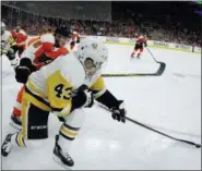  ?? TOM MIHALEK — THE ASSOCIATED PRESS ?? Philadelph­ia Flyers’ Travis Sanheim, left, chases Pittsburgh Penguins’ Conor Sheary, right, who controls the pucks during the second period in Game 3 of an NHL first-round hockey playoff series Sunday in Philadelph­ia, Pa. The Penguins won 5-1.