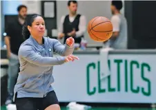  ?? CHARLES KRUPA/ASSOCIATED PRESS FILE PHOTO ?? Kara Lawson, then an assistant coach with the Celtics, passes a ball at the team’s training facility in Boston in 2019.