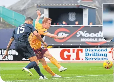  ??  ?? Motherwell’s Danny Johnson scores the first goal of the game at Dens Park