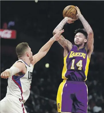  ?? Ryan Kang Associated Press ?? LAKERS ROOKIE Brandon Ingram returned from a three-game absence to score 18 points, 10 during the fourth quarter, with five rebounds and three assists. Here he gets off a shot over the Clippers’ Blake Griffin.