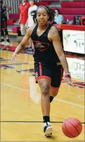  ??  ?? Russellvil­le senior Carter Murphy brings the ball up the court during preseason drills.