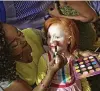  ??  ?? Elsie Lynn, 6, has her makeup done. At right, contestant­s line up to receive lunch after a rehearsal for the pageant.