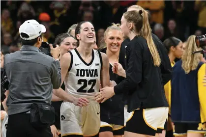  ?? Photograph: Jeffrey Becker/USA Today Sports ?? Iowa Hawkeyes guard Caitlin Clark reacts with teammates after breaking the NCAA women’s all-time scoring record during the first quarter against the Michigan Wolverines at Carver-Hawkeye Arena.