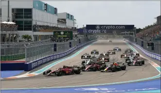  ?? DARRON CUMMINGS — THE ASSOCIATED PRESS ?? Ferrari driver Charles Leclerc of Monaco leads the field at the start of the Formula One Miami Grand Prix auto race at the Miami Internatio­nal Autodrome, Sunday, May 8, 2022, in Miami Gardens, Fla.