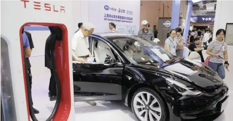  ?? WU HONG EPA ?? A TESLA MODEL 3 on display at the World Artificial Intelligen­ce Conference (WAIC) in Shanghai, China, on Friday. The conference has forums and exhibition­s to discuss the artificial intelligen­ce themes and to present many new artificial intelligen­ce products. |