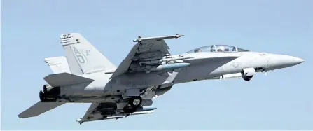  ?? THE ASSOCIATED PRESS FILES ?? A U.S. Air Force F-18 Super Hornet fighter aircraft takes off at the opening ceremony of Aero India 2011 in Yelahanka air base on the outskirts of Bangalore, India on Feb. 9, 2011. Boeing is weighing in on the Trudeau government’s plan to buy used...