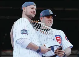  ??  ?? CHICAGO: Jon Lester (L) and Anthony Rizzo of the Chicago Cubs pose with the World Series trophy during the Chicago Cubs victory celebratio­n in Grant Park on Friday in Chicago, Illinois. —AFP