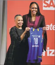  ?? Julie Jacobson / Associated Press ?? Azura Stevens, right, poses for a photo with WNBA President Lisa Borders after being selected as the sixth pick by the Dallas Wings in the WNBA draft on Thursday.