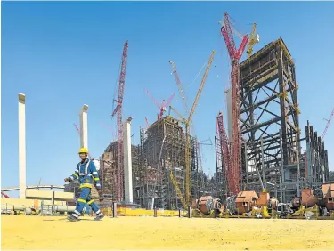  ?? FILE PICTURE ?? COAL FACE: A constructi­on worker walks through the site of the Kusile power station