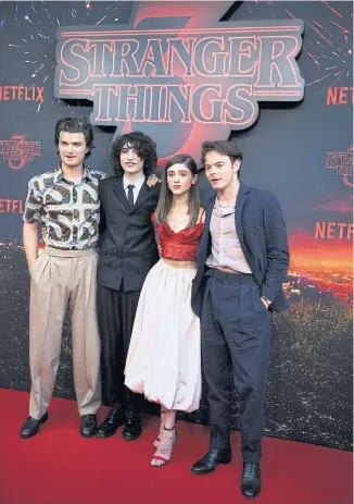  ?? AFP ?? FROM LEFT US actor Joe Keery, Canadian actor Finn Wolfhard, US actress Natalia Dyer and British actor Charlie Heaton pose during a photocall for the premiere of season 3 of the Netflix series ‘Stranger Things’ at Le Grand Rex in Paris on July 4, 2019. The series drew 64 million households in the first four weeks it was available, according to Netflix.