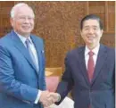  ??  ?? ... Datuk Seri Najib Abdul Razak greeting China’s Public Security Minister Guo Shengkun during the latter’s courtesy visit to the prime minister in Putrajaya yesterday.