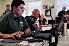  ?? Associated Press ?? ■ Fort Worth Police Sgt. Rachel DeHoyos leads an operation to catch targets soliciting minors online August 8 in Fort Worth. Authoritie­s from several agencies participat­ed in the two-day detail.