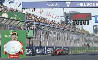  ?? (AAP/DPA) ?? Spanish Formula 1 driver Carlos Sainz of Ferrari (inset: with the trophy) crosses the finish line to win the Australian Grand Prix 2024 at Albert Park Circuit in Melbourne on Sunday.