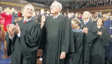  ?? Larry Downing Getty Images ?? UNLIKE IN past terms, retiring Justice Anthony M. Kennedy, center, voted with conservati­ves in every close case this year. Now Chief Justice John G. Roberts Jr., left, can steer the court on a conservati­ve course.