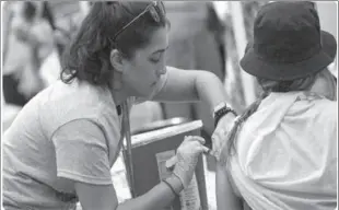  ??  ?? NEW YORK
A person gets the COVID-19 vaccine at the 2021 NYC Pride Fest in New York City.
-APP