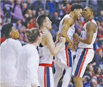  ?? THE ASSOCIATED PRESS ?? Gonzaga guard Jordan Mathews, right, celebrates with teammates after scoring during the second half of their West Regional semifinal against West Virginia on Thursday night in San Jose, Calif.