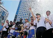  ?? [AP PHOTO] ?? Members of the Golden State Warriors gather before the start of the team’s championsh­ip parade Tuesday in Oakland, Calif.