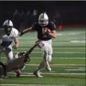  ?? PETE BANNAN – DIGITAL FIRST MEDIA ?? Garnet Valley quarterbac­k Cole Palis escapes into the open field on a first-half run in what became a 4914 Jaguars victory over Quakertown Friday night.