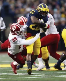  ?? PAUL SANCYA — THE ASSOCIATED PRESS ?? Michigan running back Karan Higdon runs as Indiana defensive back Khalil Bryant makes the tackle Nov. 17 in Ann Arbor, Mich.