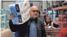  ?? GETTY IMAGES ?? A customer carries a package of toilet paper at a Costco store on March 14 in Novato, Calif.