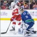  ?? The Canadian Press ?? Henrik Zetterberg of the Detroit Red Wings looks for a rebound in front of Vancouver Canucks goalie Jacob Markstrom during Monday’s game.