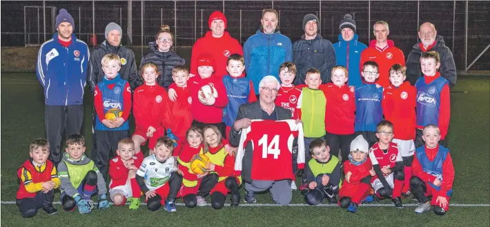  ?? Photograph: Sandie Maciver of SandiePhot­os ?? Alasdair Nicholson with young Point FC players and representa­tives from the club and Point and Sandwick Trust.