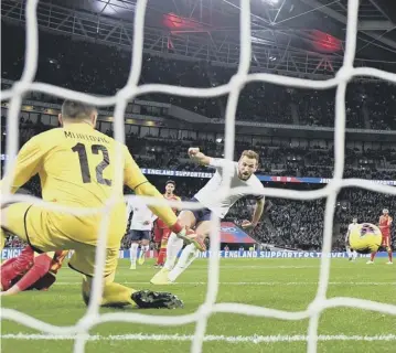  ??  ?? 0 Harry Kane completes his hat-trick as he scores England’s fifth goal against Montenegro.