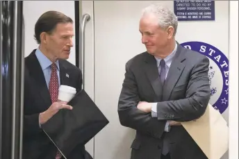  ?? Alex Brandon / Associated Press ?? Sen. Richard Blumenthal, D-Conn., left, and Sen. Chris Van Hollen, D-Md., stand in the subway on Capitol Hill on Tuesday in Washington.