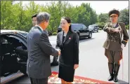  ?? AP ?? Kim Yo Jong, North Korean leader Kim Jong Un’s sister, greets South Korean President Moon Jae-in as he arrives Saturday on the north side of the border village of Panmunjom to hold talks with her brother.