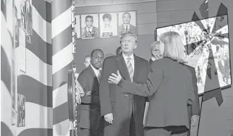  ?? Susan Walsh / Associated Press ?? President Donald Trump gets a tour Saturday of the Mississipp­i Civil Rights Museum in Jackson. Housing and Urban Developmen­t Secretary Ben Carson, left, joined the president on the tour.