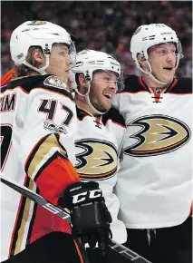  ?? DAVID BLOOM ?? Anaheim Ducks teammates Hampus Lindholm, Chris Wagner and Josh Manson, left to right, celebrate a goal against the Oilers during the second period in Edmonton on Sunday.