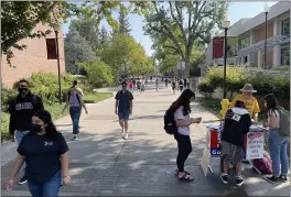  ?? PHOTOS BY JUSTIN COUCHOT — ENTERPRISE-RECORD ?? Chico State students walk to classes and register to vote on the first day of school at Chico State in Chico.