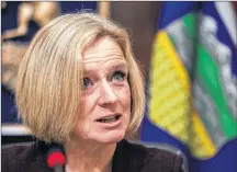  ?? CP PHOTO ?? Alberta Premier Rachel Notley speaks to cabinet members about an 8.7 percent oil production cut to help deal with low prices, in Edmonton on Monday.