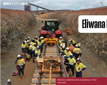  ??  ?? Workers celebrate the completion of the rail track.