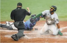  ?? Mike Carlson / Getty Images ?? The A’s Elvis Andrus is called out at home by umpire Sean Barber after a tag by Rays catcher Mike Zunino in the seventh.