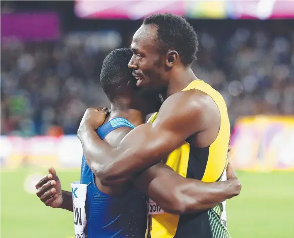  ?? Picture: GETTY IMAGES ?? Usain Bolt hugs Justin Gatlin after the US star won the men's 100m final in London, reigniting debate over drug bans in sport.