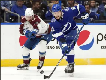  ?? CHRIS O’MEARA — THE ASSOCIATED PRESS ?? Tampa Bay Lightning defenseman Erik Cernak, right, and Avalanche right wing Valeri Nichushkin chase a loose puck during the first period on Thursday in Tampa, Fla.