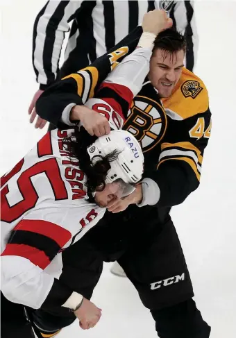  ?? ?? SHOWING SOME FIGHT: Defenseman Josh Brown, right, dropped the gloves with New Jersey’s Mason Geertsen in his first game as a Bruin.