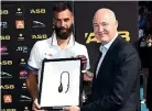  ??  ?? Auckland Tennis chairman Simon Vannini presents France’s Benoit Paire with the runner-up trophy.