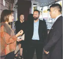  ?? THE CANADIAN PRESS / HANDOUT / FILES ?? Stephen Peddle, centre, and Sangeen Abdul Mateen are seen at a dinner in September for Mateen,
veterans and their families in Edmonton.